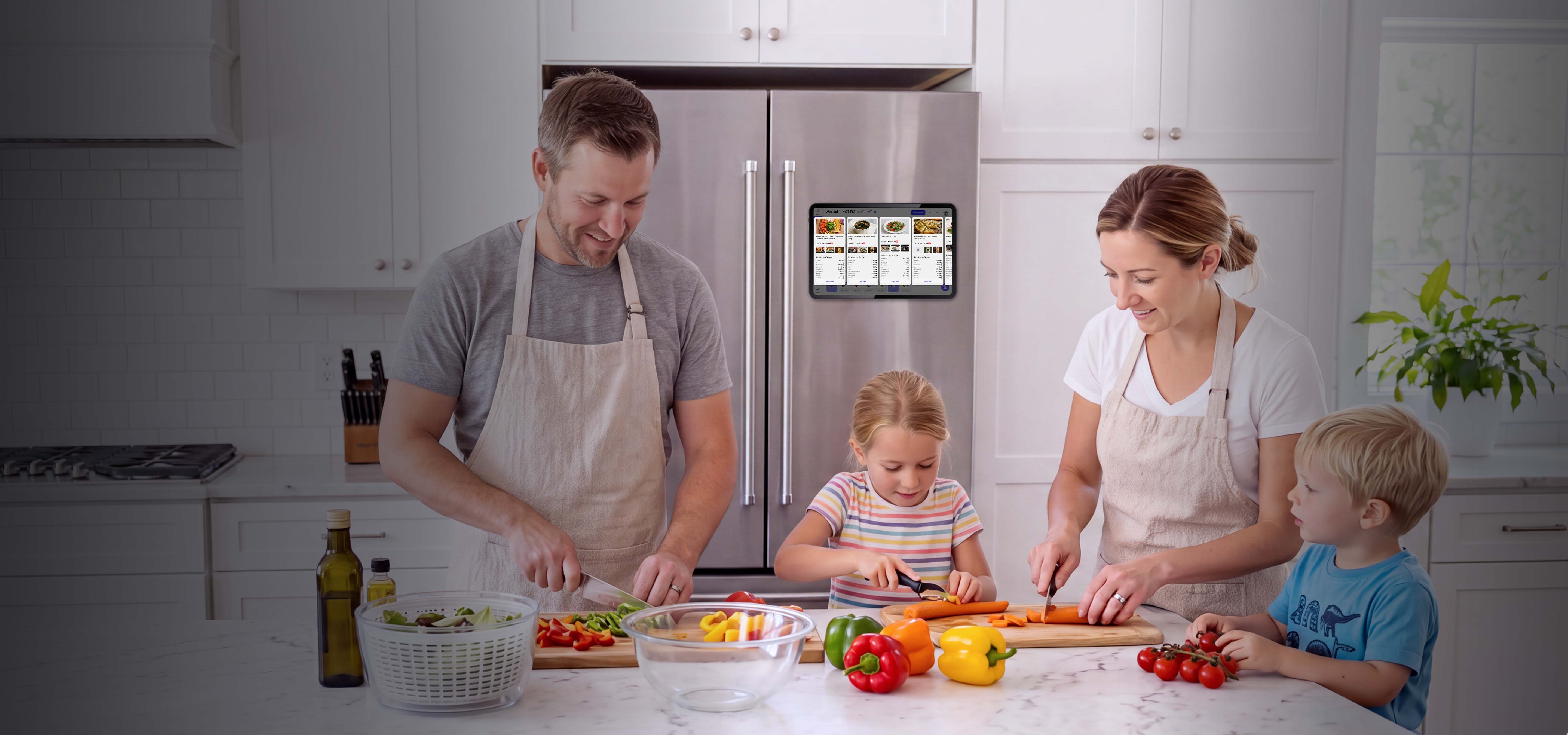 Family of four prepare food beside a fridge with digital meal planner and grocery list on the fridge door
