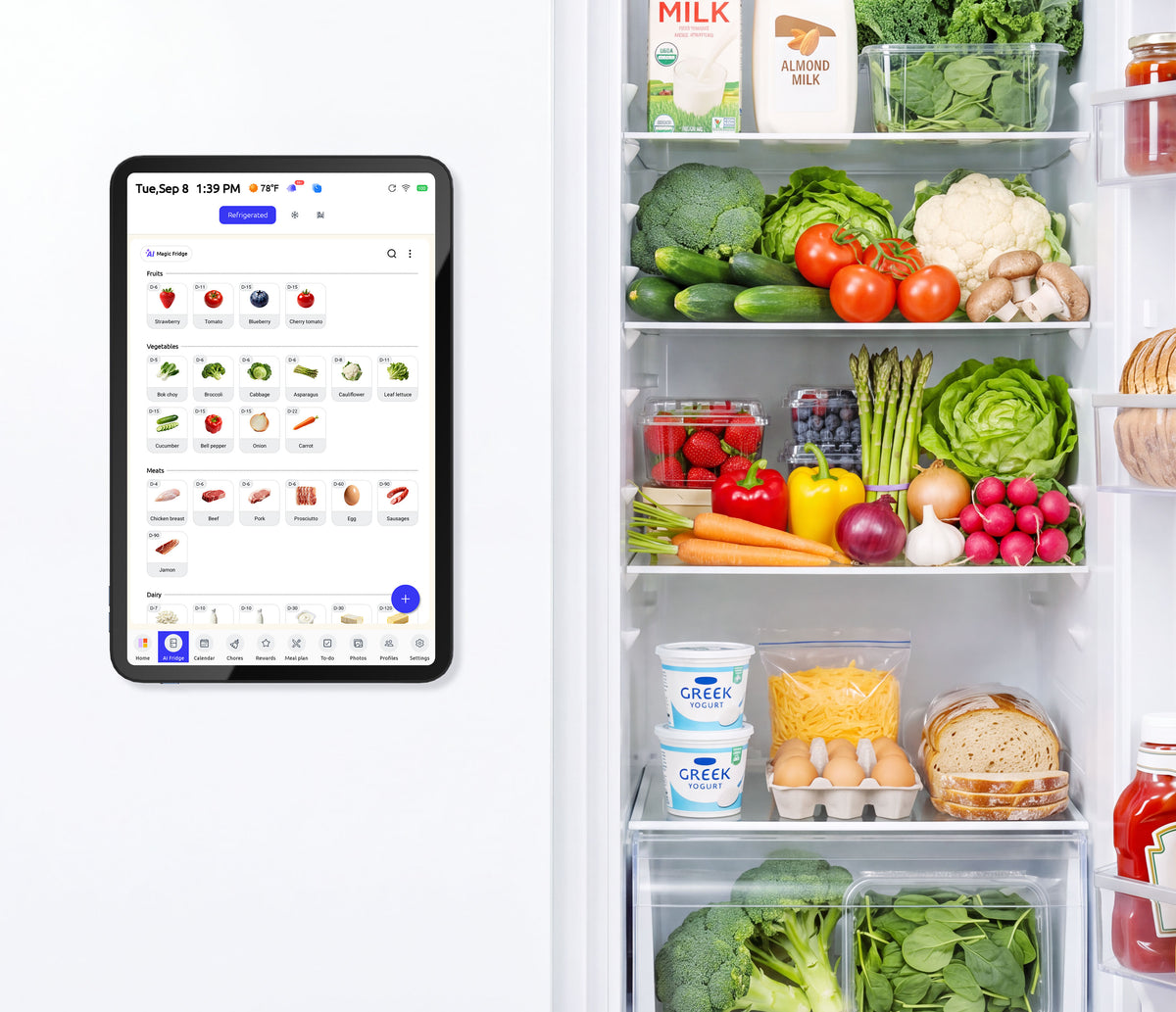 FridgeCal smart tablet tracks food inventory beside open fridge stocked with fresh produce