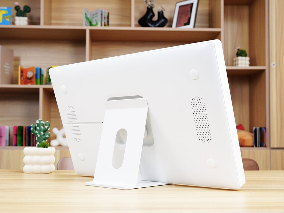 White Everblog digital calendar stand on a wooden table, showing the back of the calendar and its sturdy base.